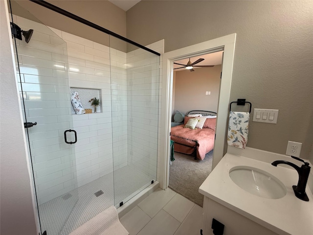 bathroom featuring tile patterned floors, an enclosed shower, and vanity