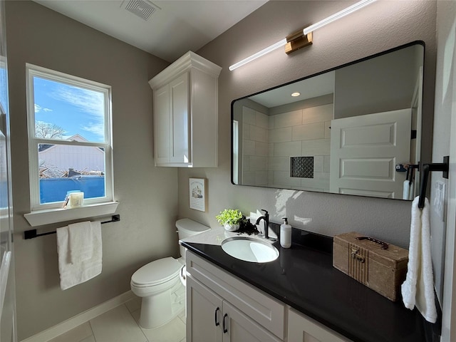 bathroom featuring vanity, tile patterned floors, and toilet