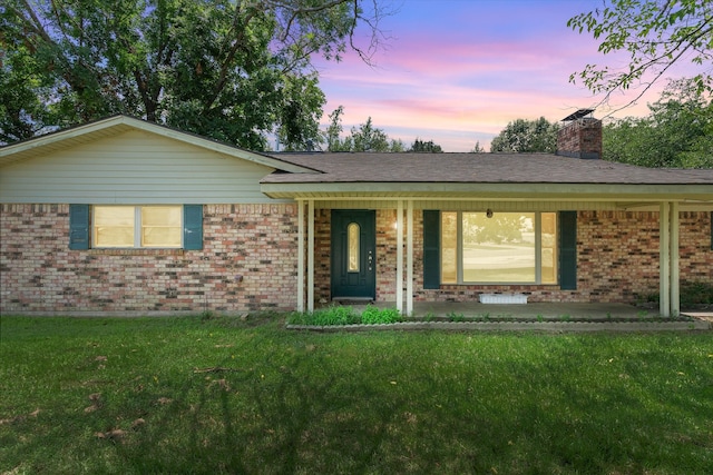 ranch-style home featuring a yard