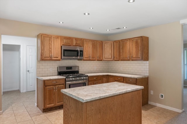 kitchen with stainless steel appliances, a center island, tasteful backsplash, and light tile patterned floors