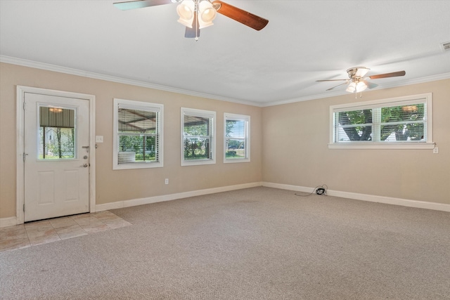 foyer entrance featuring light colored carpet, ornamental molding, a wealth of natural light, and ceiling fan