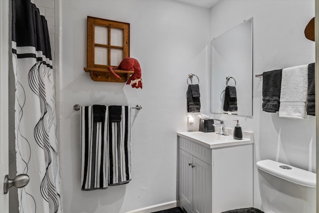 bathroom featuring vanity and toilet