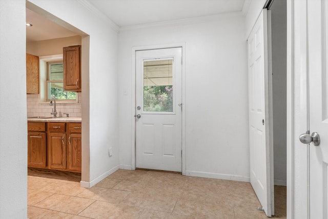 doorway with sink, light tile patterned flooring, and crown molding