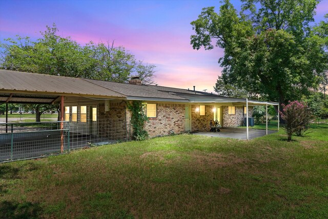 view of front of home with a patio and a yard