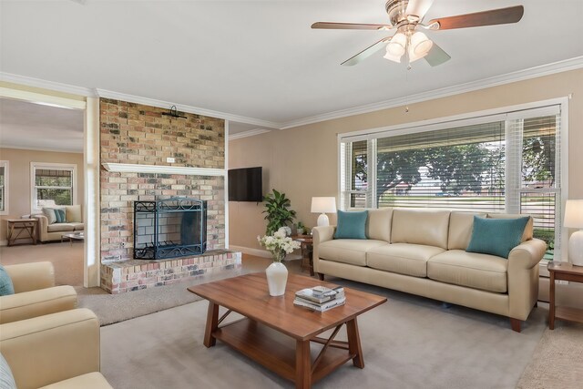 living room with ceiling fan, crown molding, a brick fireplace, and light colored carpet