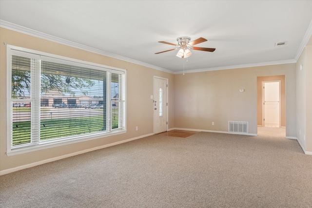 carpeted empty room with crown molding and ceiling fan