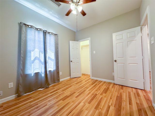 full bathroom with hardwood / wood-style flooring, toilet, shower / bath combo with shower curtain, and vanity