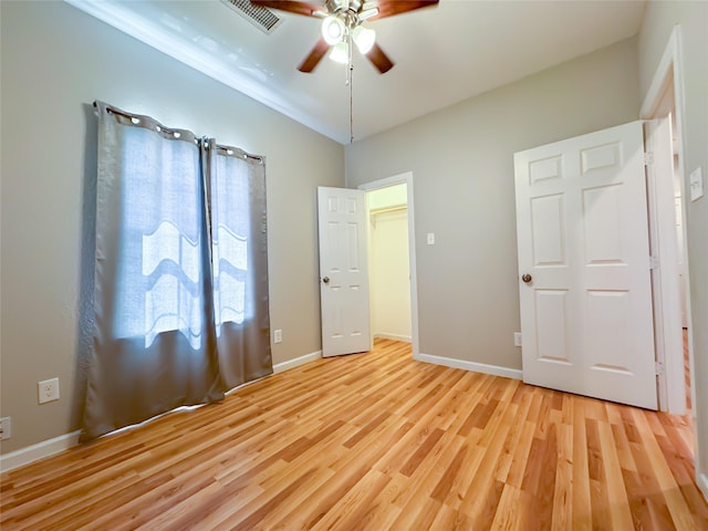 unfurnished bedroom with baseboards, visible vents, ceiling fan, and light wood finished floors