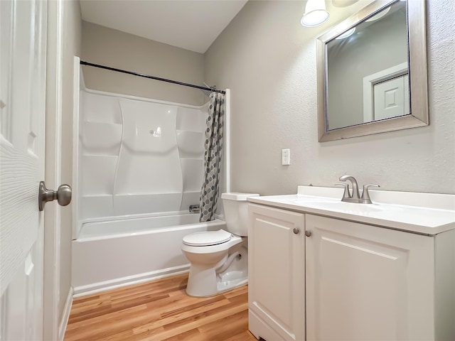 bathroom featuring shower / tub combo, vanity, toilet, and wood finished floors