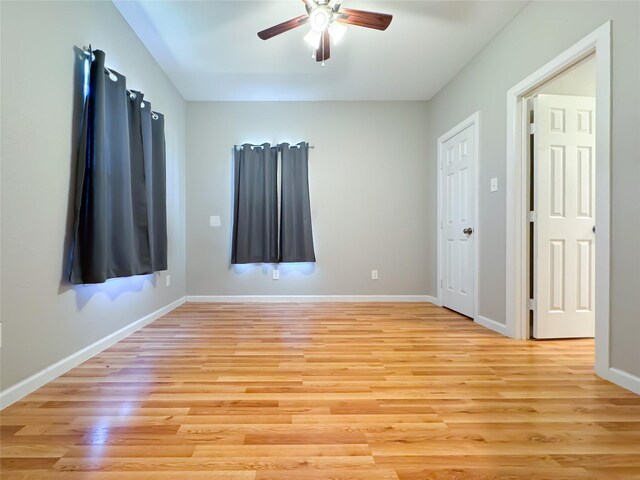 bathroom with wood-type flooring, walk in shower, and vanity