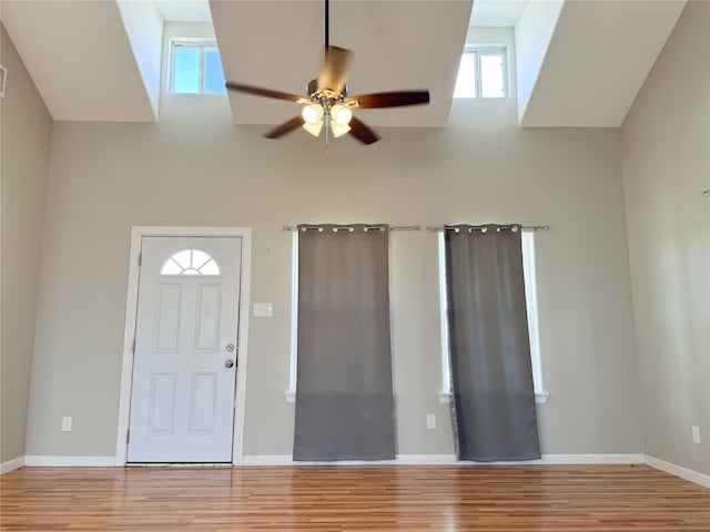 kitchen featuring white appliances, high vaulted ceiling, white cabinetry, and light hardwood / wood-style flooring