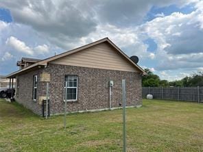 view of property exterior featuring a yard and fence