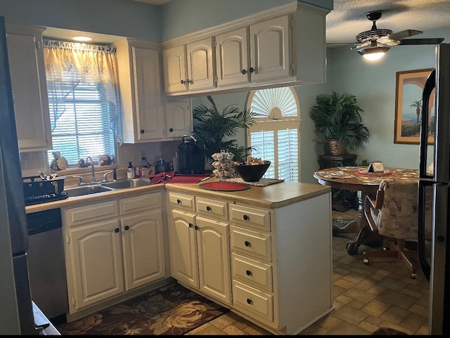 kitchen with tile patterned floors, ceiling fan, tasteful backsplash, and a healthy amount of sunlight