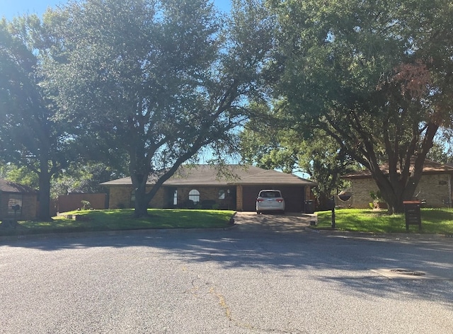 single story home with a garage and a front yard