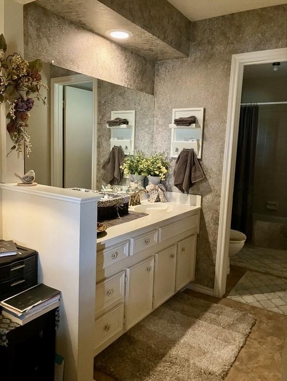 bathroom featuring tile patterned floors, toilet, and vanity