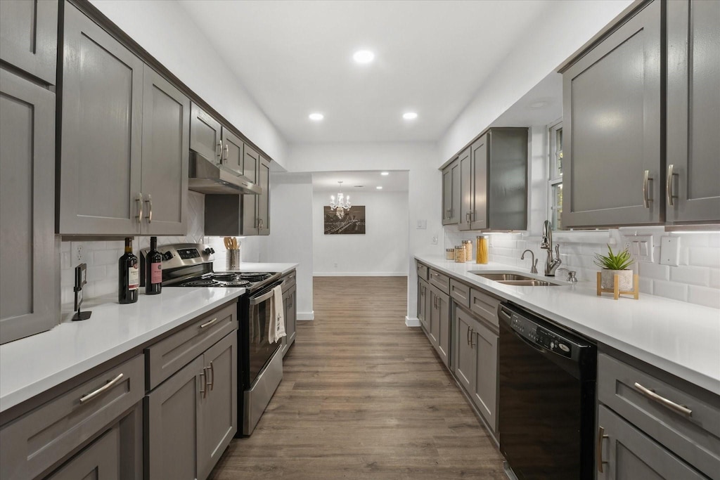 kitchen featuring dark wood-type flooring, sink, dishwasher, gray cabinets, and stainless steel electric range