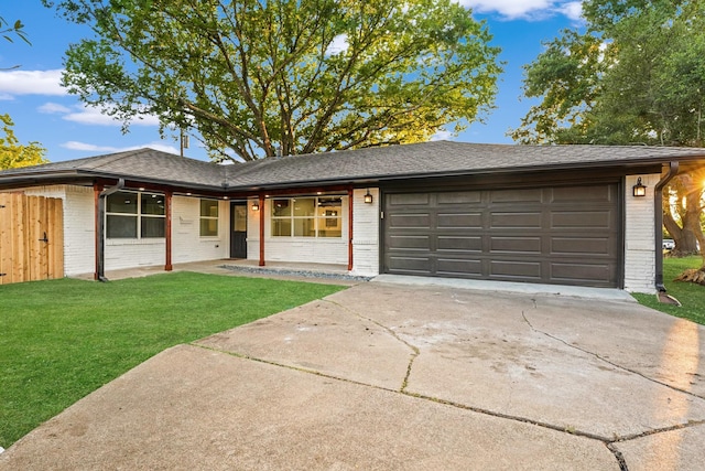 single story home featuring a front lawn and a garage