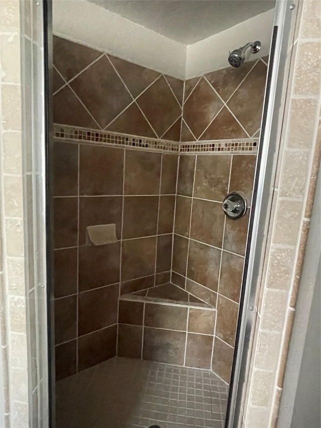 bathroom with a tile shower