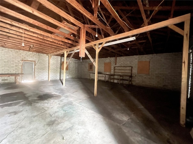 basement featuring brick wall