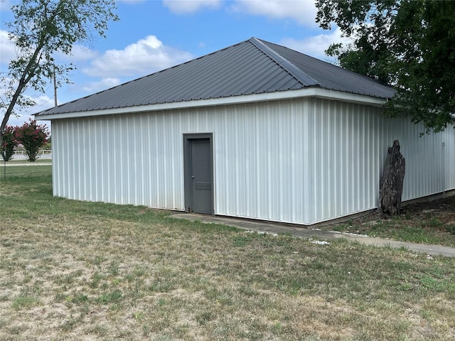 view of outdoor structure with a lawn