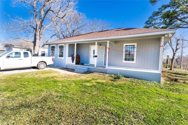 view of front of property with a front yard and a porch