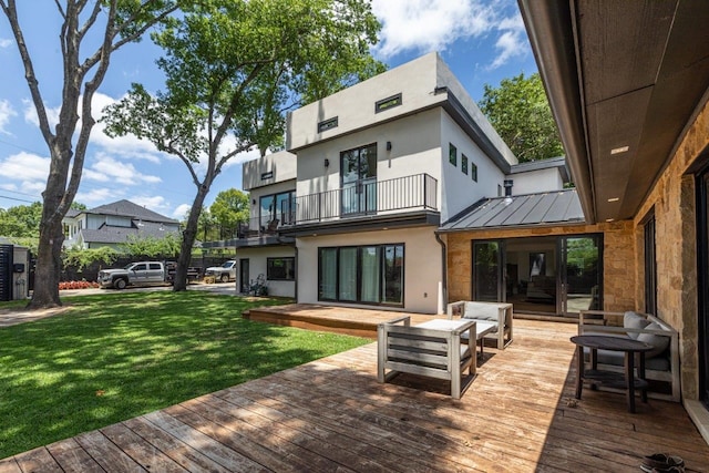 rear view of property with a wooden deck, a balcony, a yard, and outdoor lounge area