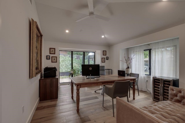 office featuring ceiling fan, lofted ceiling, wine cooler, and light wood-type flooring