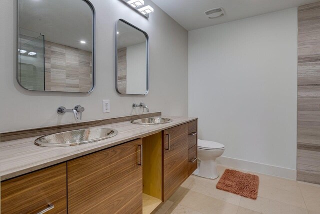 bathroom with vanity, tile patterned floors, and toilet