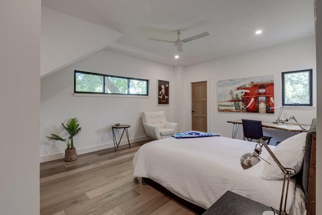 bedroom with ceiling fan and light hardwood / wood-style floors