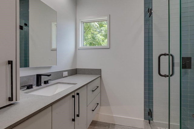 bathroom featuring tile patterned flooring, vanity, and an enclosed shower