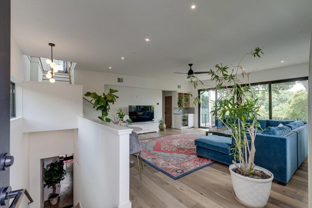 living room with wood-type flooring and ceiling fan