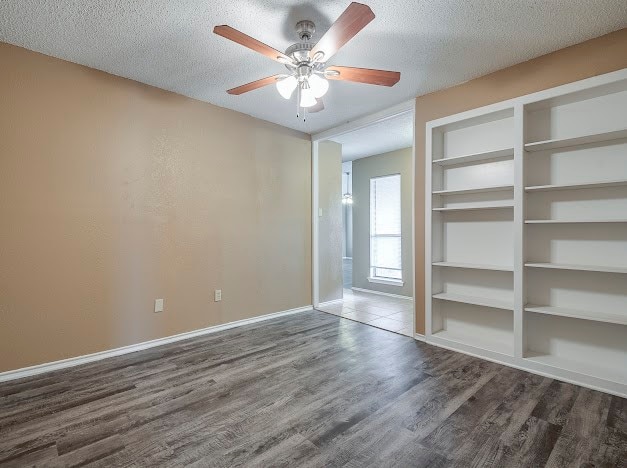 unfurnished bedroom with a textured ceiling, ceiling fan, and hardwood / wood-style flooring