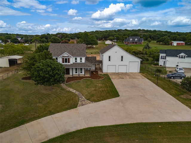 view of front of home featuring a garage, an outbuilding, and a front yard