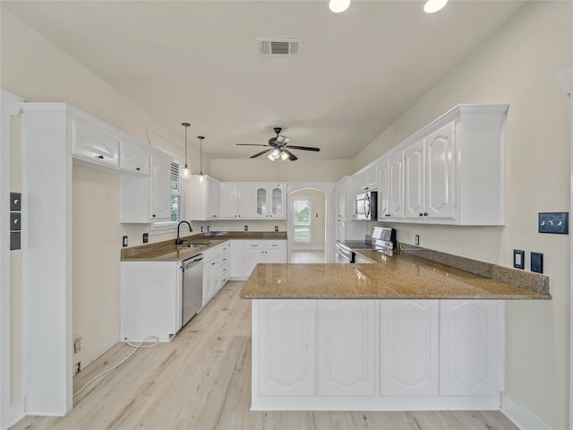 kitchen featuring white cabinetry, stainless steel appliances, sink, light hardwood / wood-style flooring, and kitchen peninsula