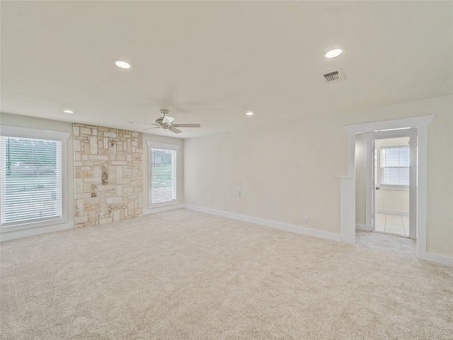 unfurnished living room with light carpet and ceiling fan