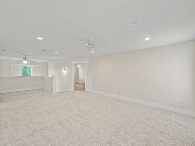 unfurnished room featuring light carpet and ceiling fan