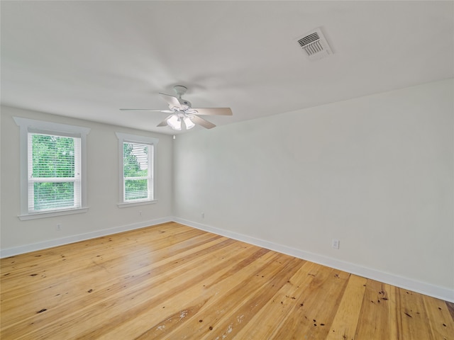 spare room featuring light hardwood / wood-style flooring and ceiling fan