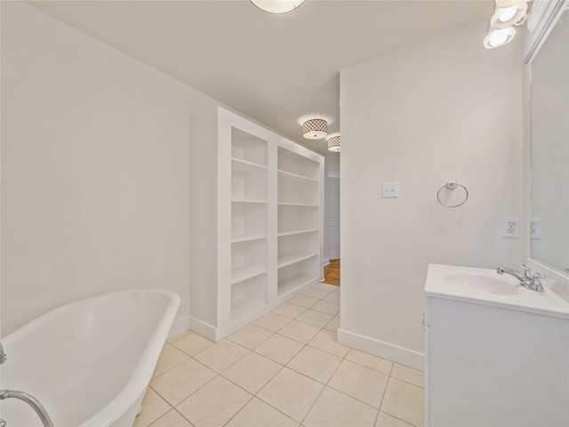 bathroom featuring built in shelves, vanity, a washtub, and tile patterned flooring