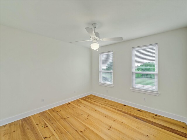 spare room featuring light hardwood / wood-style flooring and ceiling fan