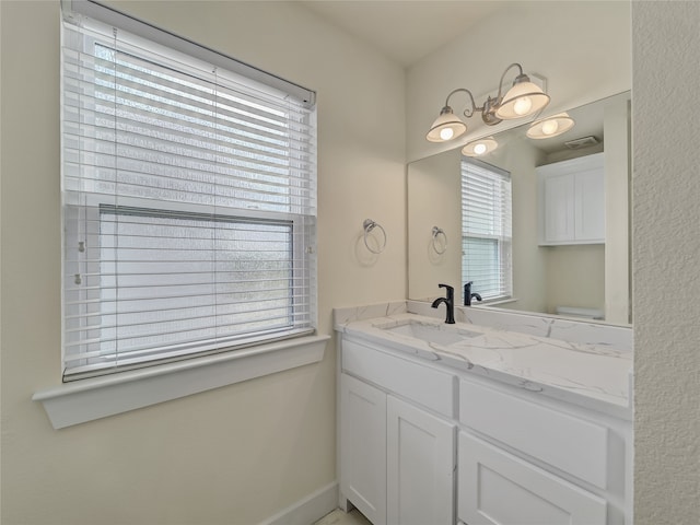 bathroom featuring plenty of natural light and vanity