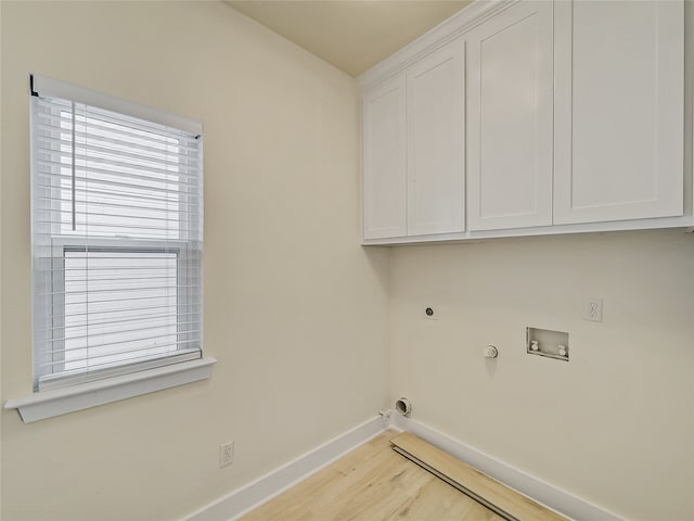 laundry room with hookup for an electric dryer, hookup for a gas dryer, light hardwood / wood-style floors, cabinets, and hookup for a washing machine