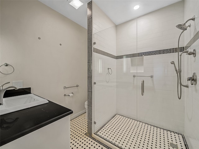 bathroom featuring dual vanity, toilet, and an enclosed shower