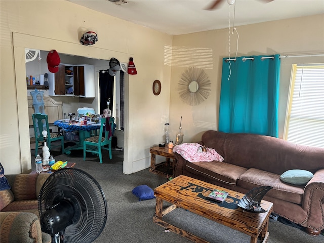 carpeted living room with ceiling fan