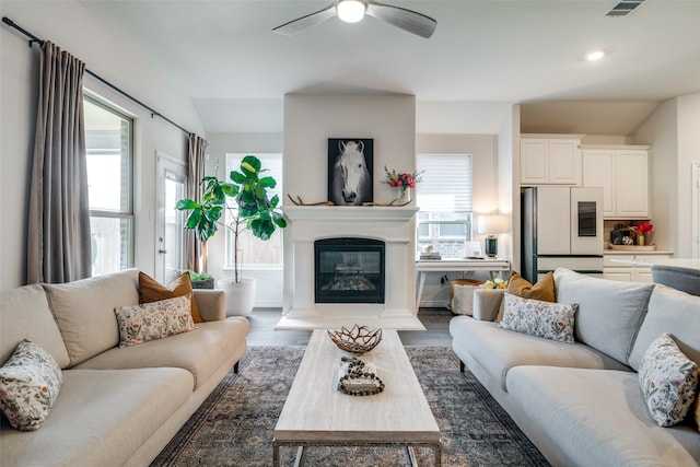 living room featuring ceiling fan and hardwood / wood-style floors