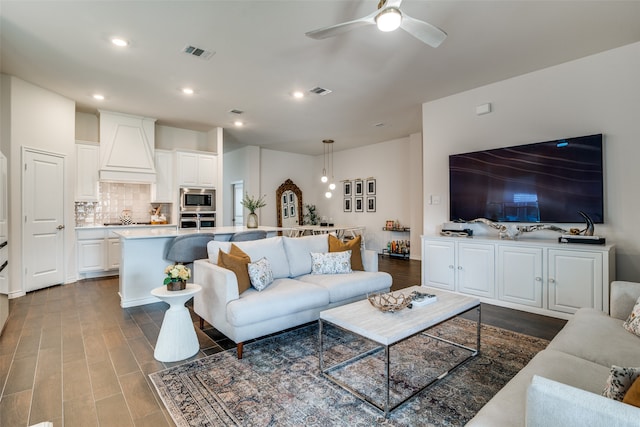 living room featuring light hardwood / wood-style flooring and ceiling fan