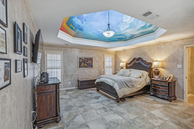 bedroom with crown molding and a raised ceiling