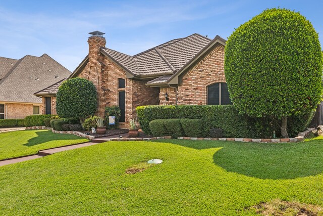 tudor home featuring a front yard