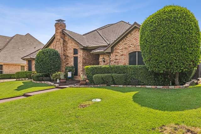 tudor house featuring a front lawn