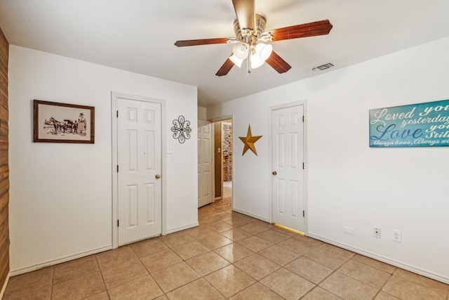 unfurnished room featuring ceiling fan and light tile patterned flooring