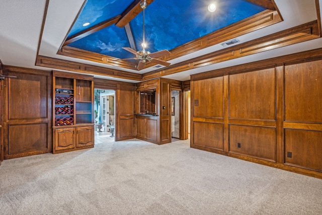 unfurnished bedroom featuring crown molding, light colored carpet, and a tray ceiling